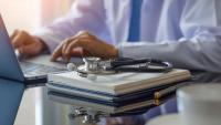 doctor using laptop at his desk